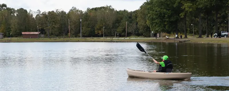 A kayaker paddling the stocked lake at Krodel Park